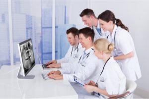 dentists studying an xray
